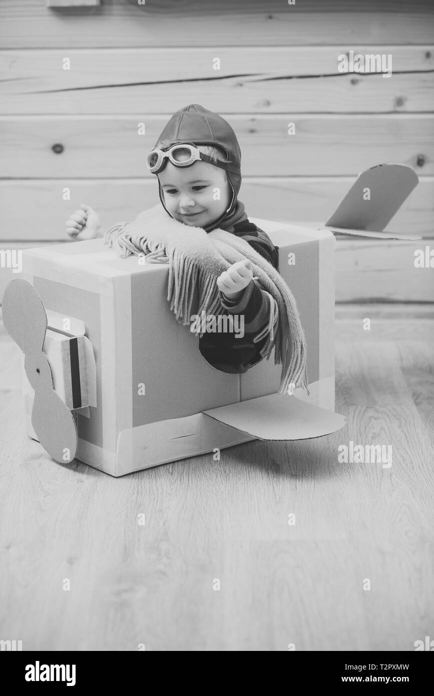 Little child boy in aviator costume is playing and dreaming of becoming ...