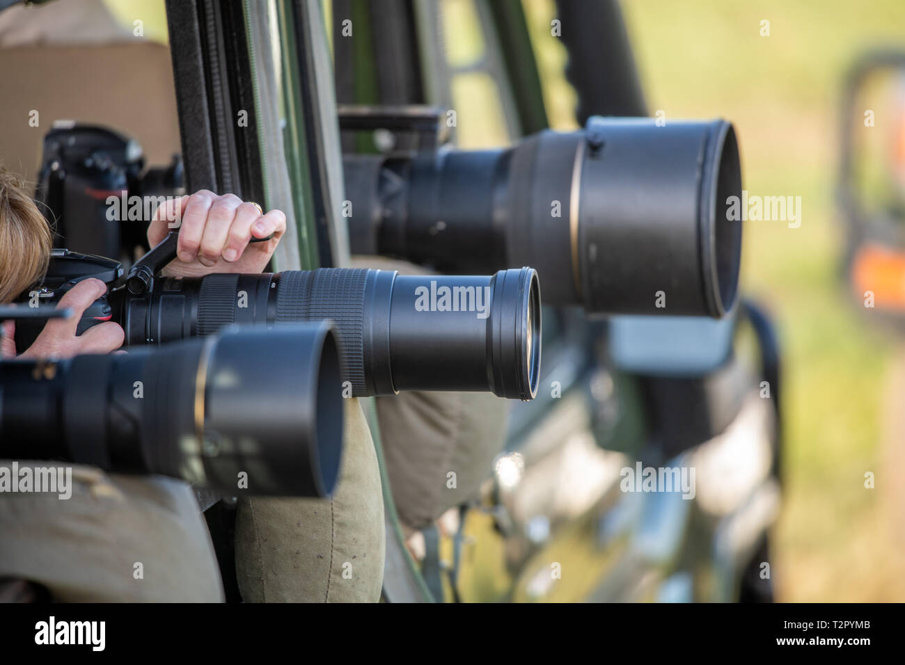 Photographers ready their cameras with lenses lined up in action at