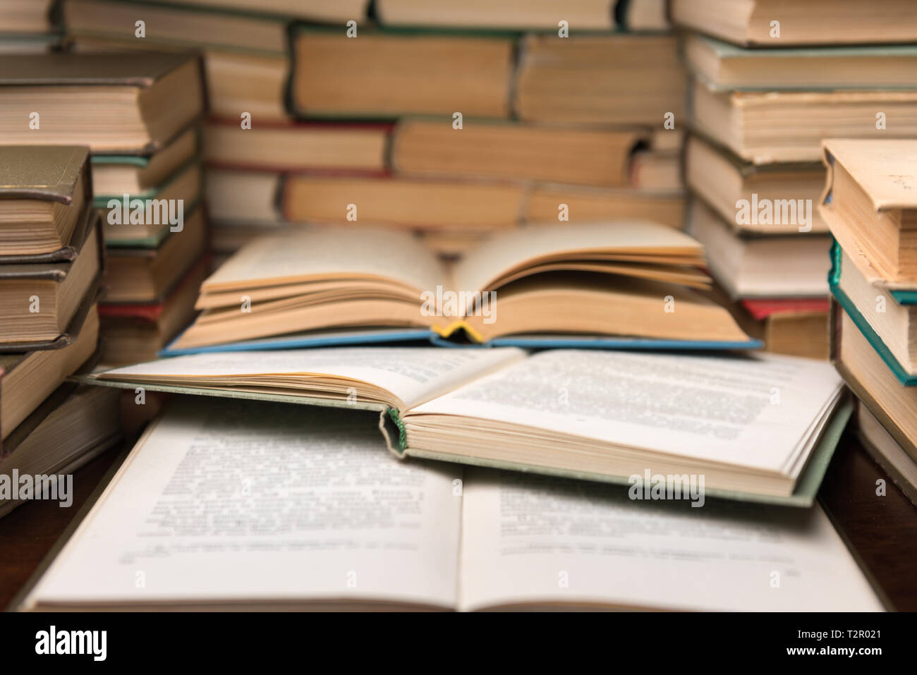 Open books on wood desk in the library room with blurred focus for education background and back to school concept Stock Photo