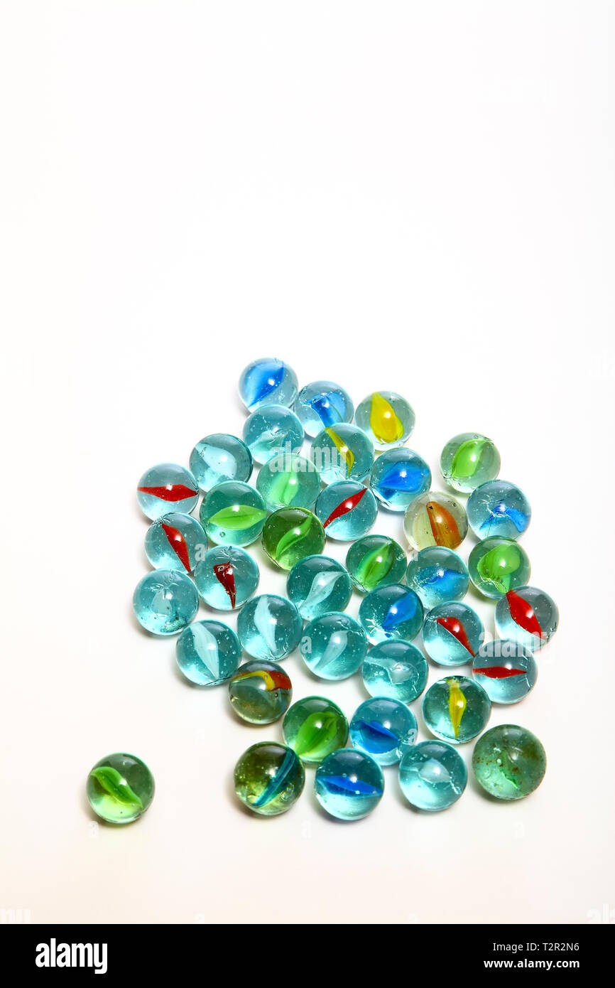 Group of glass marbles isolated on a white background with copy space