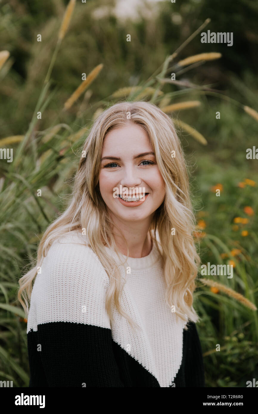 Beautiful Attractive Blond Hair Young Fair Skinned Caucasian Woman with Pretty Smile in Nature for Headshot Portraits Outside Stock Photo
