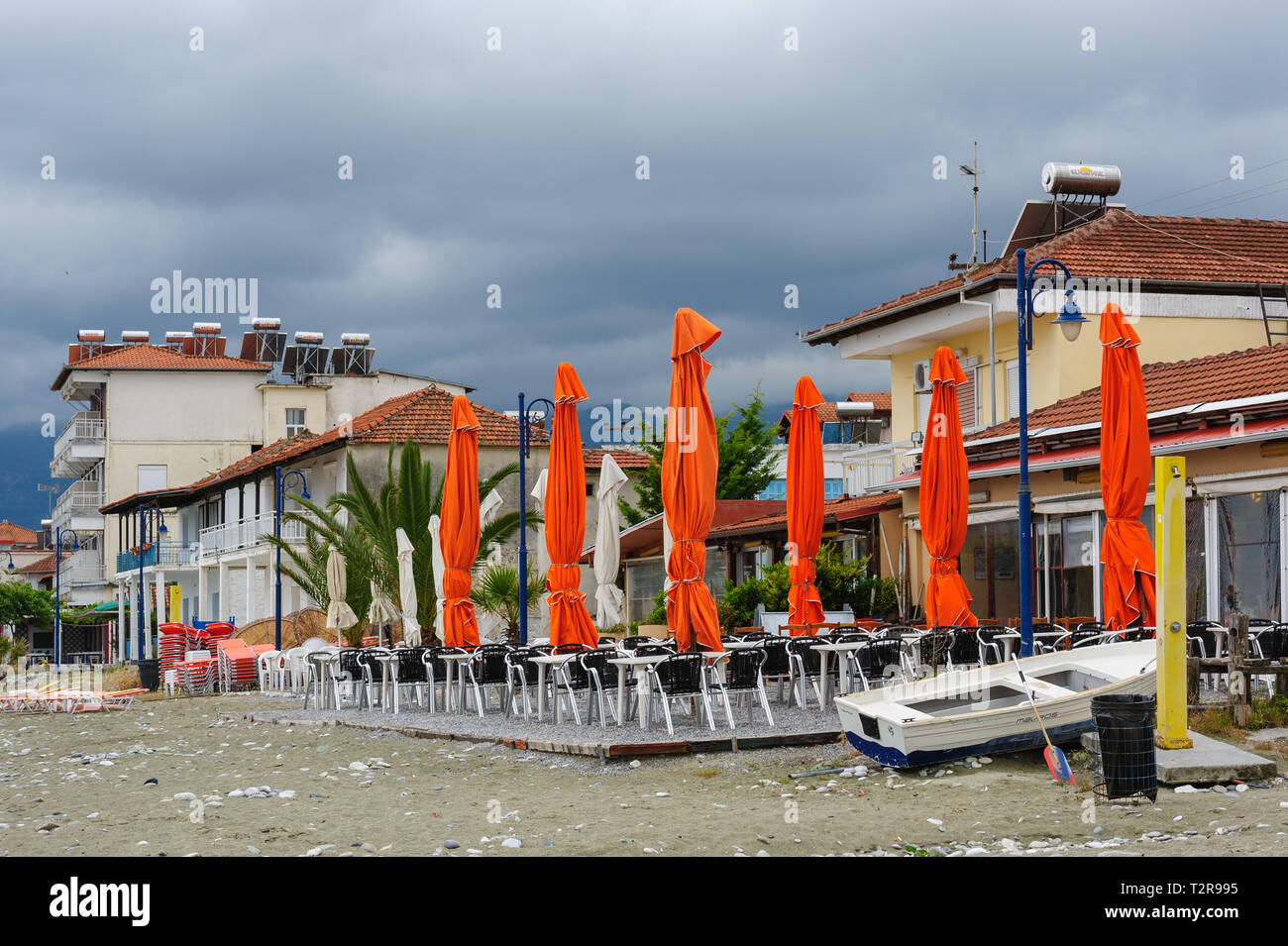 Leptokaria, Pieria, Central Macedonia, Greece - 11th May 2015: Empty outdoor cafe at the beach just prepared for the high season Stock Photo