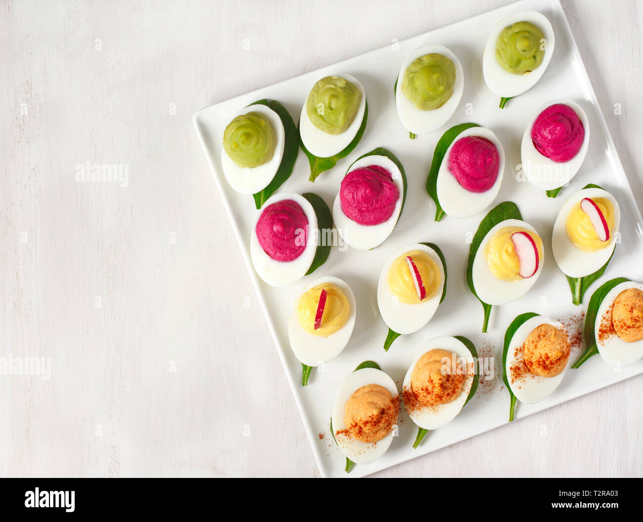 A plate of deviled eggs on dark grey stone background, top view, copy space Stock Photo
