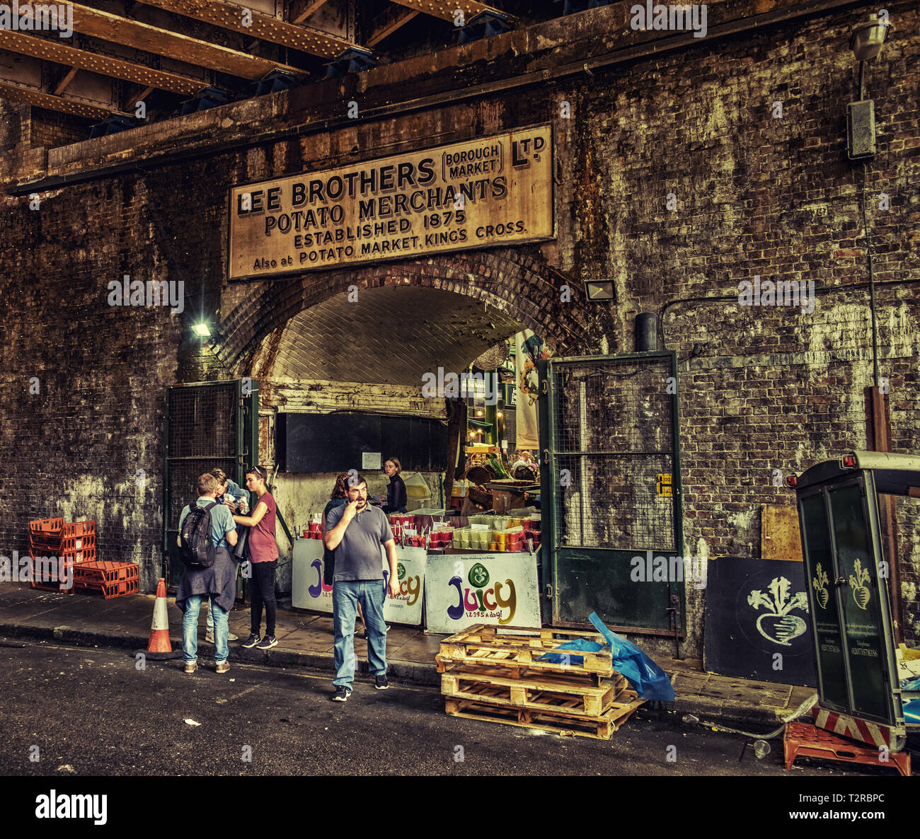 London, UK, Aug 2018, urban scene at Borough Market with an old business advertising sign above a brick arch, England Stock Photo