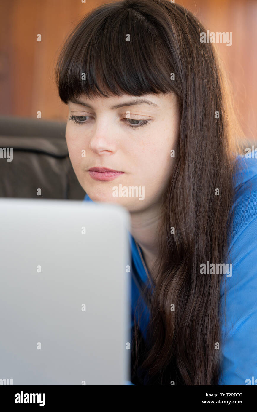 30 year old woman  on her laptop Stock Photo