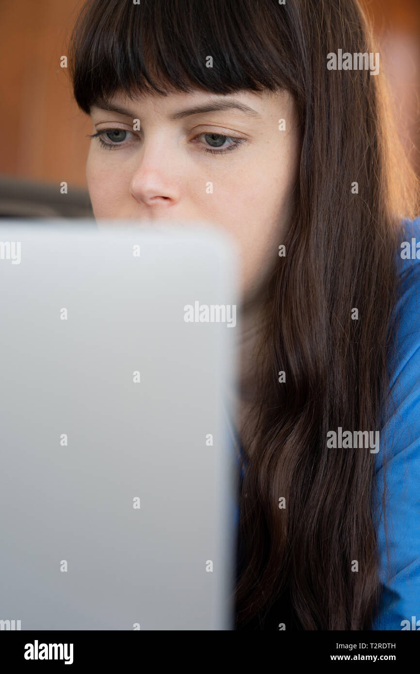 30 year old woman  on her laptop Stock Photo