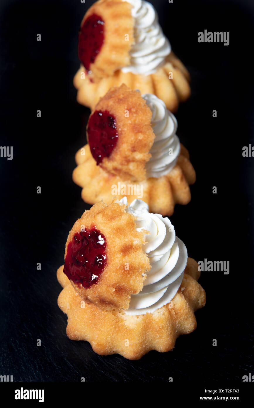 Rum baba with whipped cream and comfiture or jam Stock Photo Alamy