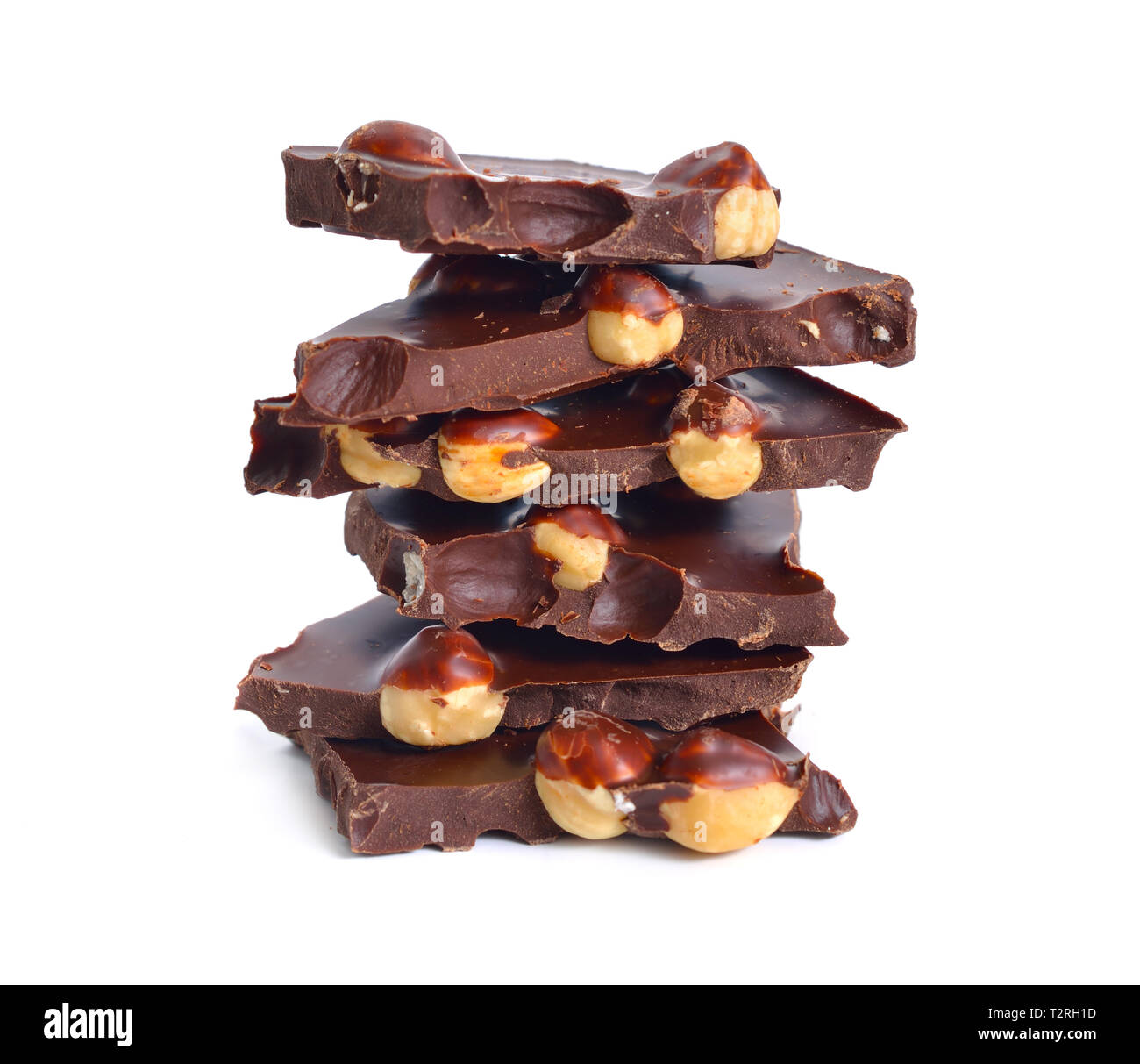 Dark chocolate with hazelnuts. Isolated on white background. Stock Photo
