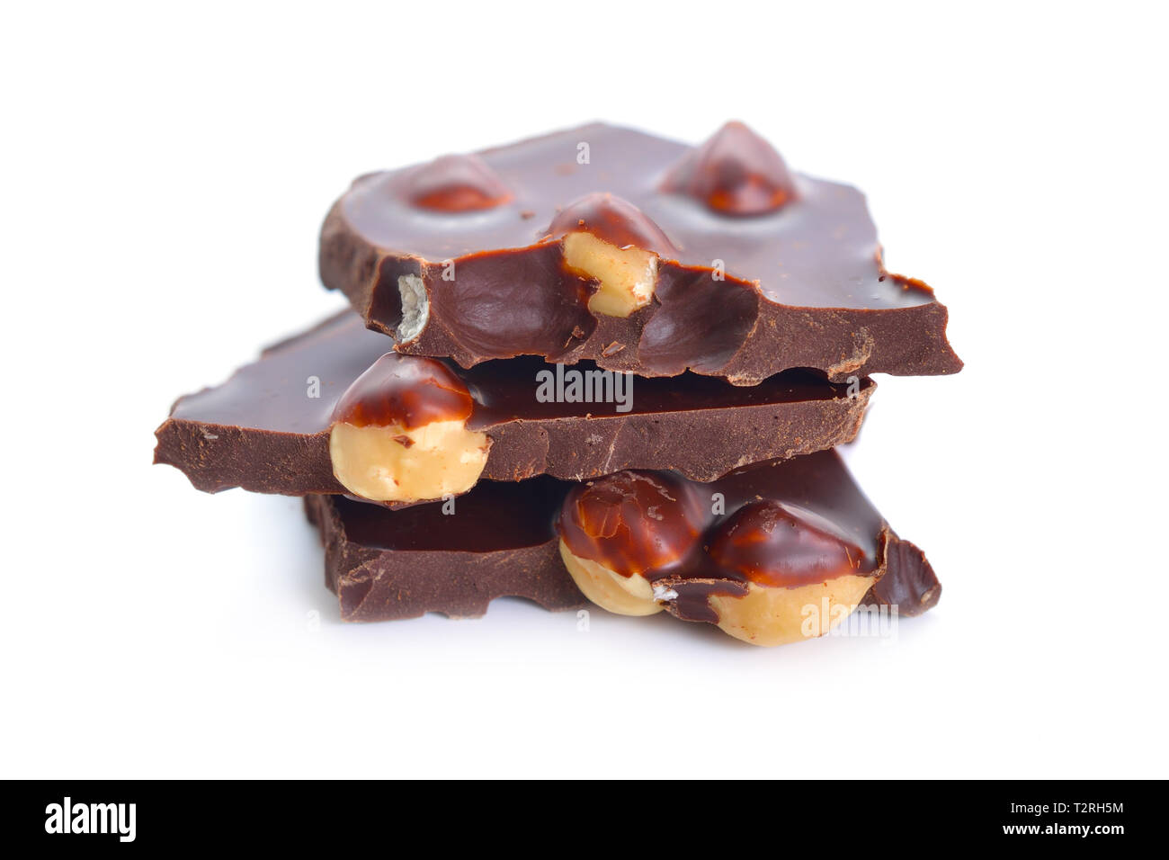 Dark chocolate with hazelnuts. Isolated on white background. Selective focus. Stock Photo