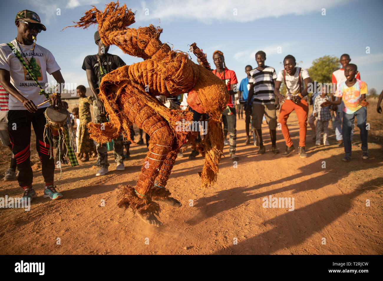 JANJANBUREH, THE GAMBIA (18/01/2019) - An Ifangbondi Kankurang dances as the sun sets over the festival ground. The Mandinka people believe this Kankurang finds and kills witches, and will most often come out at night. It is believed to fly between tress protecting circumcision initiates during the 'bush school' period.  The Janjanbureh Kankurang Festival is part of joint efforts by the EU Emergency Trust Fund for Africa and the Gambian Youth Empowerment Project to boost tourism in Janjanbureh. By preserving and celebrating the cultural heritage of the Kankurang, it is creating new economic op Stock Photo