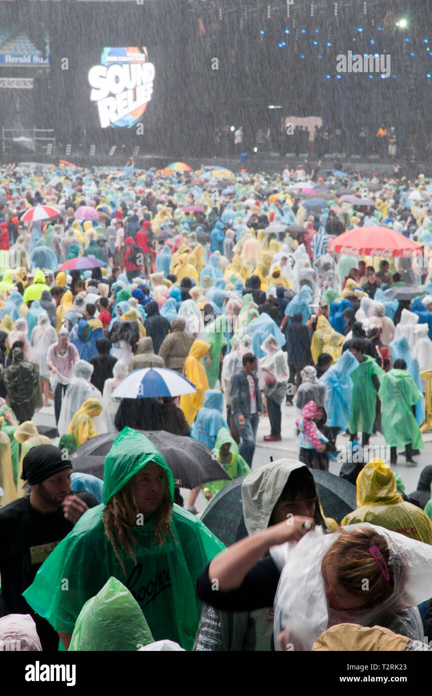 Crowds standing in the pouring rain at rock concert Stock Photo Alamy