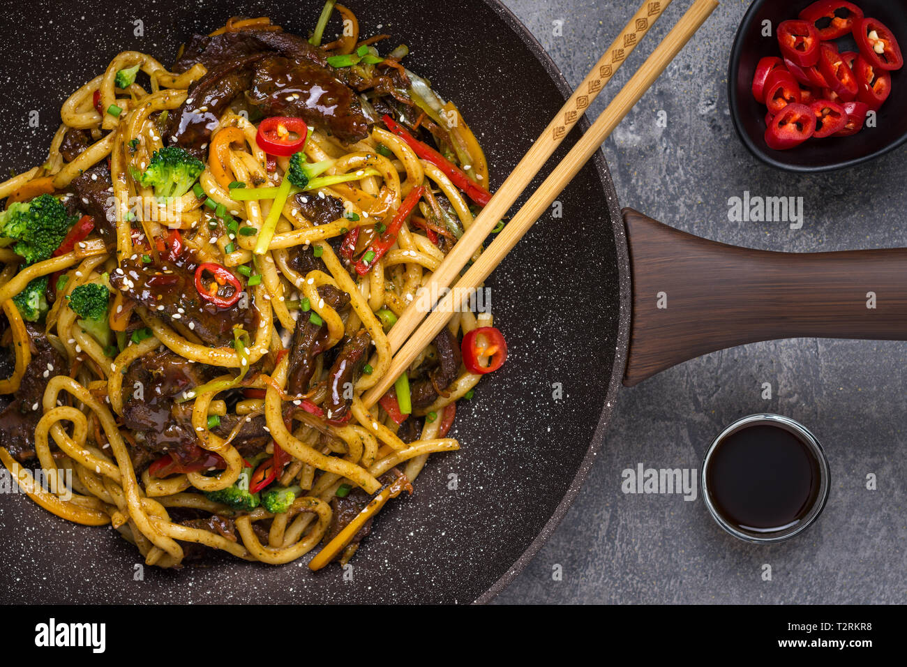 Udon Stir-Fry Noodles with Beef and Vegetables in Wok Pan on Dark  Background Stock Photo - Alamy