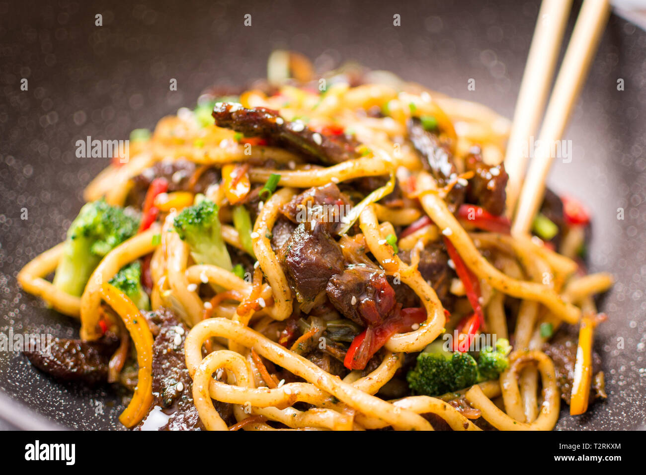 Udon Stir-Fry Noodles with Beef and Vegetables in Wok Pan on Dark  Background Stock Photo - Alamy