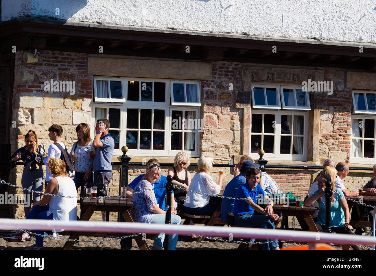 York, North Yorkshire. Kings Arms pub by the River Ouse, people having a drink and enjoying the sun. Stock Photo