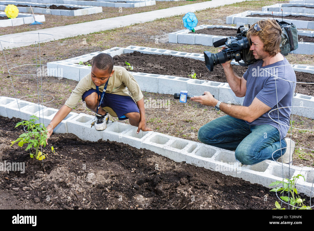 Miami Florida,Liberty City,Square,public housing,ceremony,dedication,community garden,plot,allotment,urban,Black boy boys male kids children student s Stock Photo