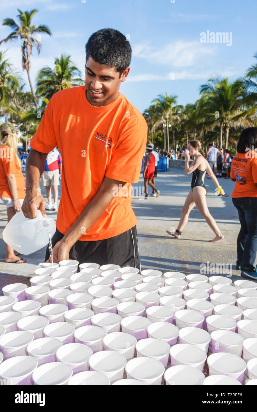 Miami Beach Florida,Lummus Park,Nautica South Beach Triathlon,competitors,sport,fitness,water station,hydrate,Black man men male,volunteer volunteers Stock Photo