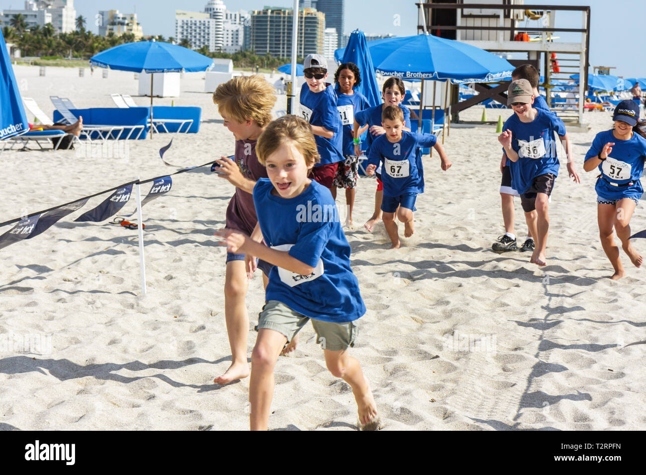 Miami Beach Florida,Nautica South Beach Triathlon,Atlantic Ocean,water,shore,sport,fitness,competition,children's race,boy boys male kids children run Stock Photo