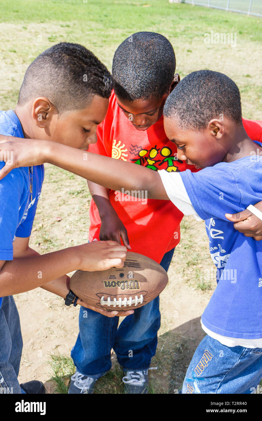 Miami Florida,Moore Park,touch football huddle,sport,game,strategy,Hispanic Black African Africans,boy boys male kids children boys,child,student stud Stock Photo