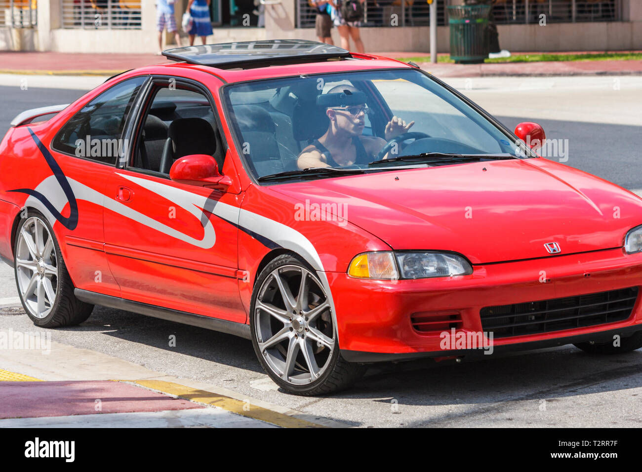 Miami Beach Florida,Ocean Drive,car cars,red,stripes,wheels,idle,sun  roof,red,Hispanic Latin Latino ethnic immigrant immigrants minority,boy  boys lad Stock Photo - Alamy