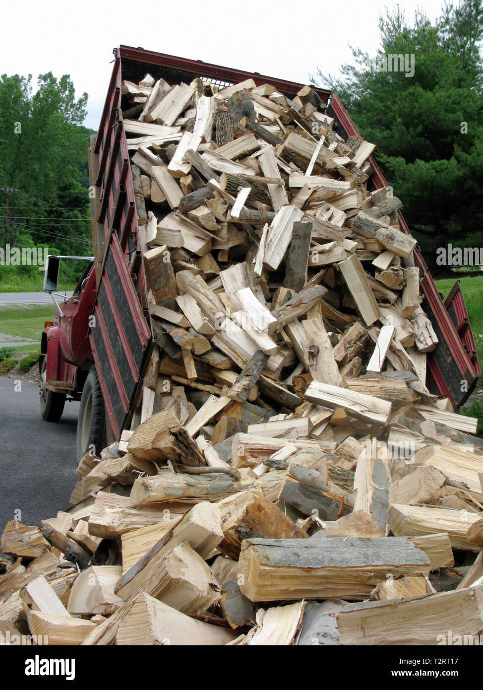 4 cords of split firewood being dumped in a Vermont driveway Stock Photo -  Alamy