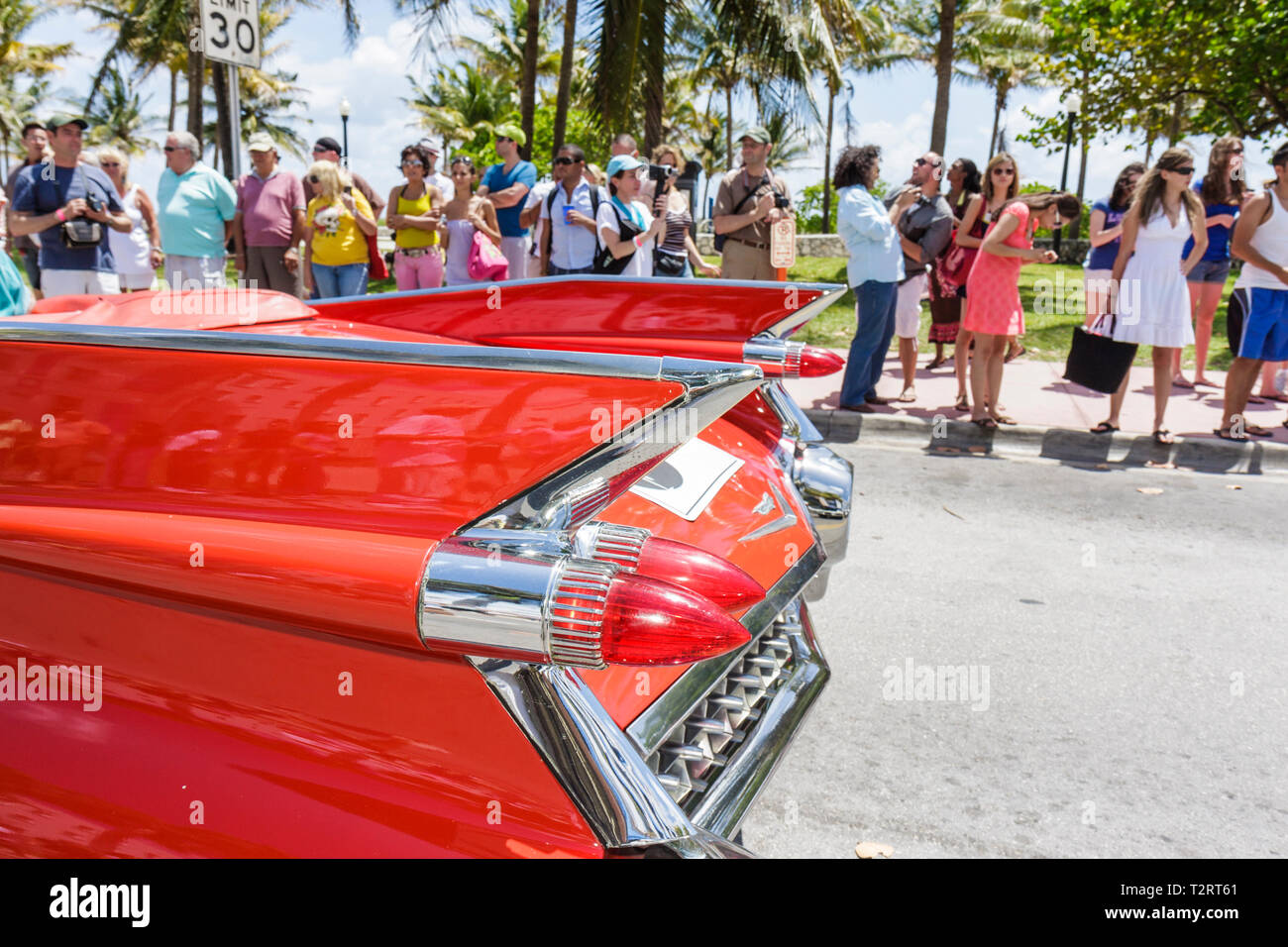 Miami Beach Florida,Ocean Drive,1959 Cadillac,red,tail fins,car cars,classic,automobile,car cars,spectator,parade,visitors travel traveling tour touri Stock Photo