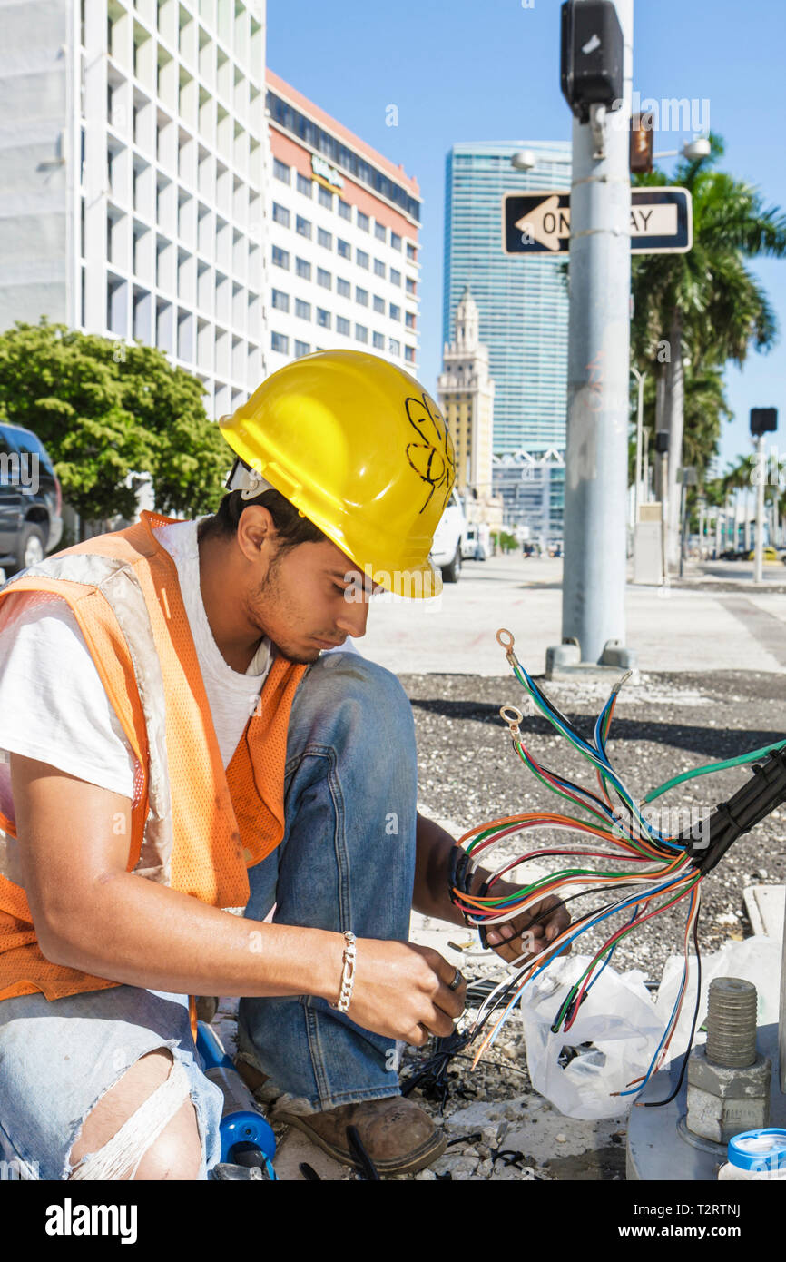 Miami Florida,Biscayne Boulevard,downtown,city worker,workers,electrician,electrical,cables,hardhat,hard hat,yellow,vest,safety vest,trade,working,wor Stock Photo