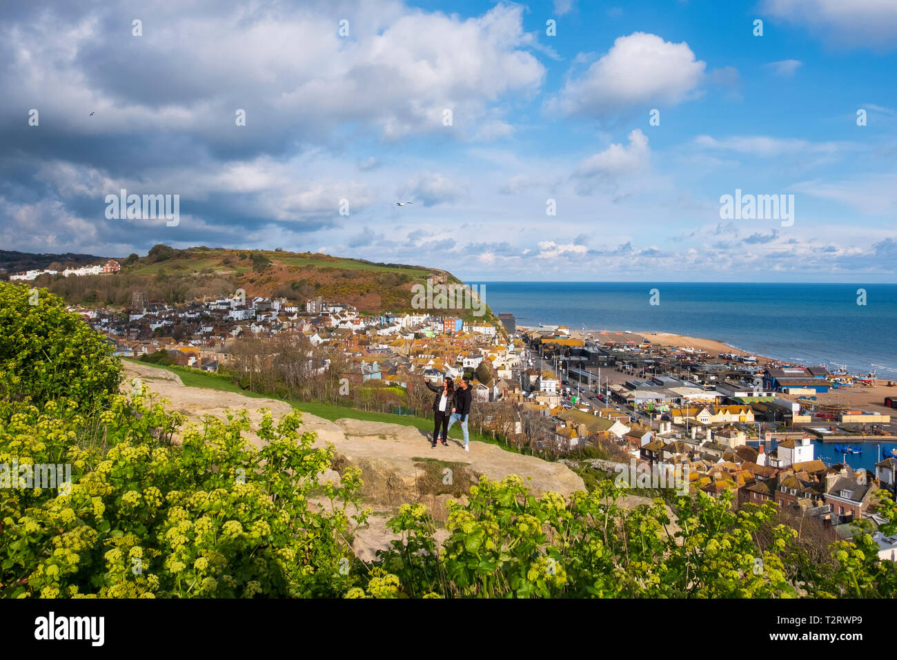 A couple take a selfie of the view from the West Hill in Hastings, overlooking the Old Town, and harbour, East Sussex, UK Stock Photo