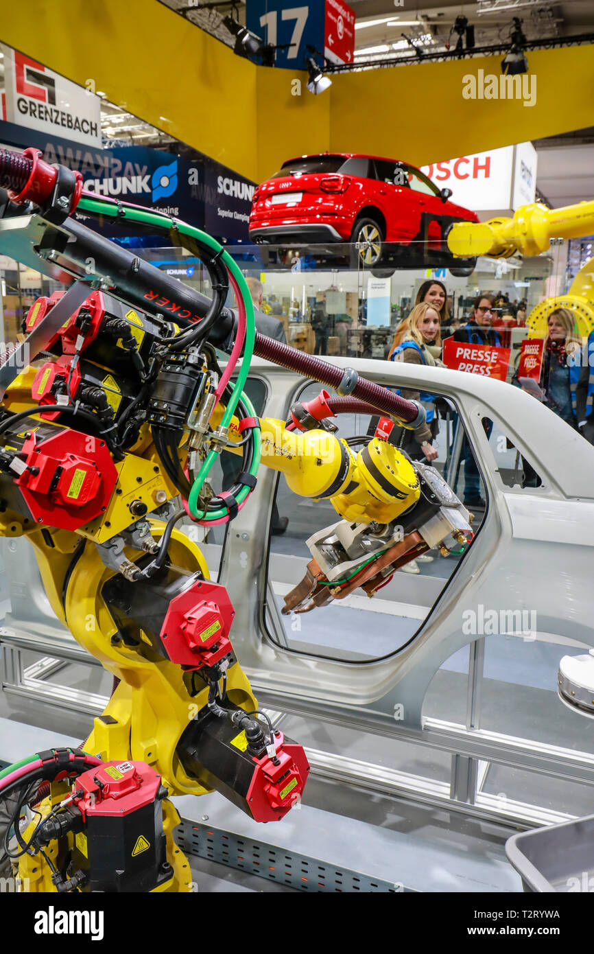 Hanover, Lower Saxony, Germany - Hanover Fair, industrial robots at the Fanuc booth welding and transporting cars, here on the press highlight tour th Stock Photo