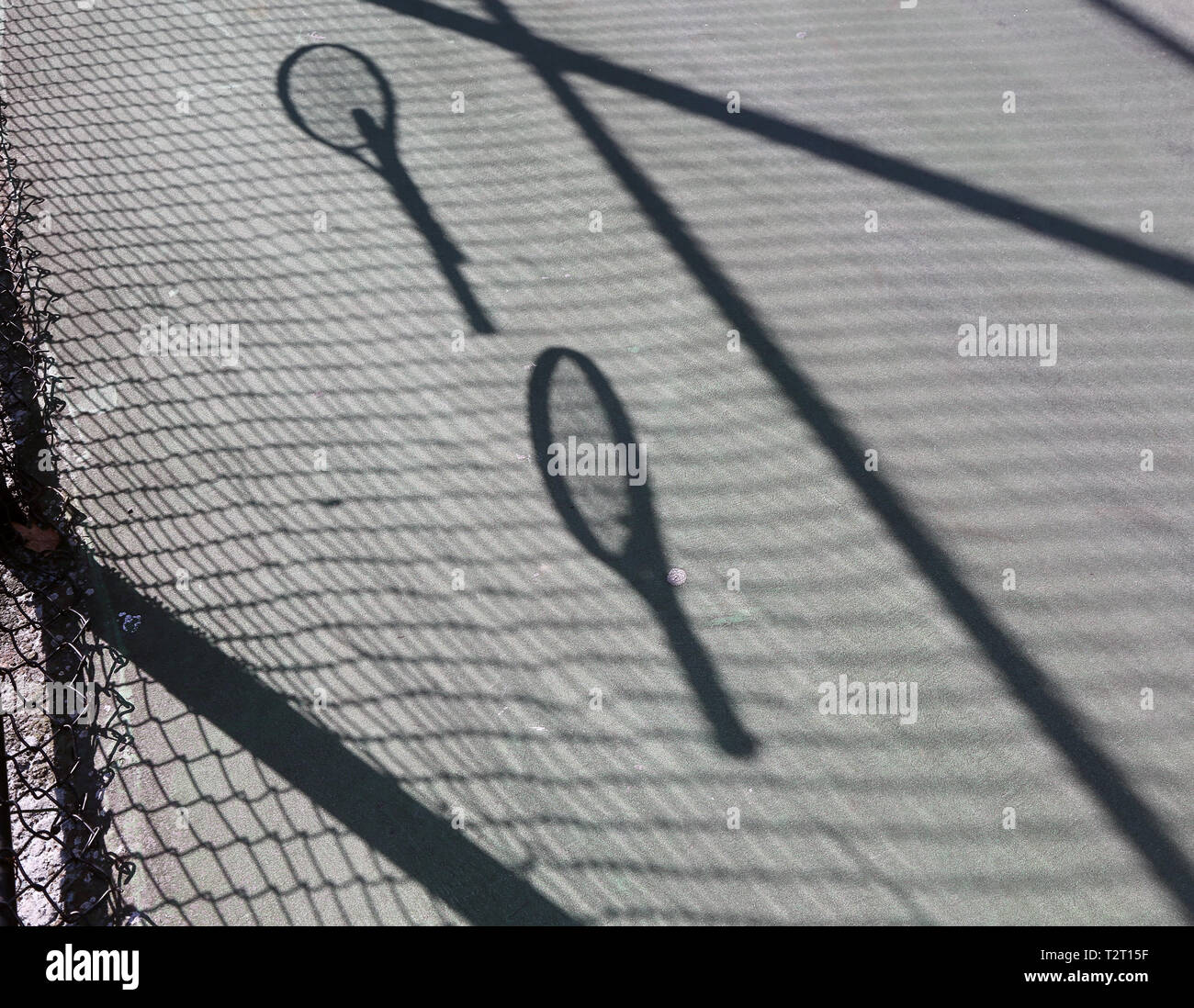 Shadows of tennis rackets on the ground Stock Photo