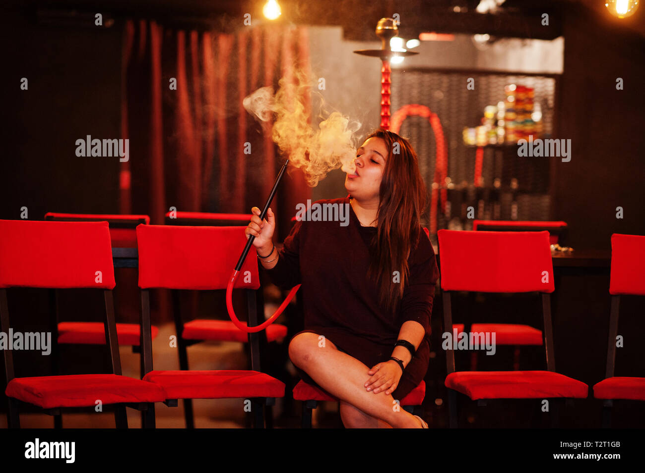 Asian girl smoke hookah at lounge bar Stock Photo Alamy