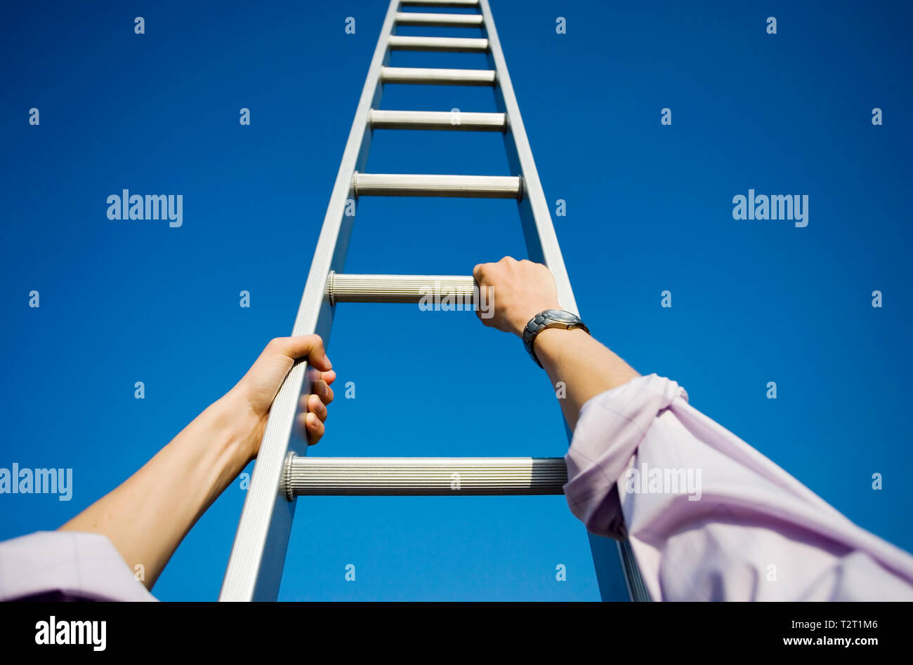 Personal perspective of a businessman climbing a ladder Stock Photo