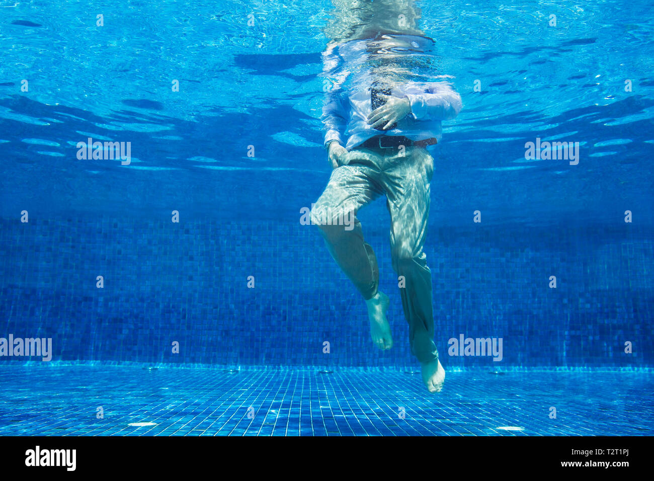 Businessman underwater themes of underwater businessman out of context challenge Stock Photo