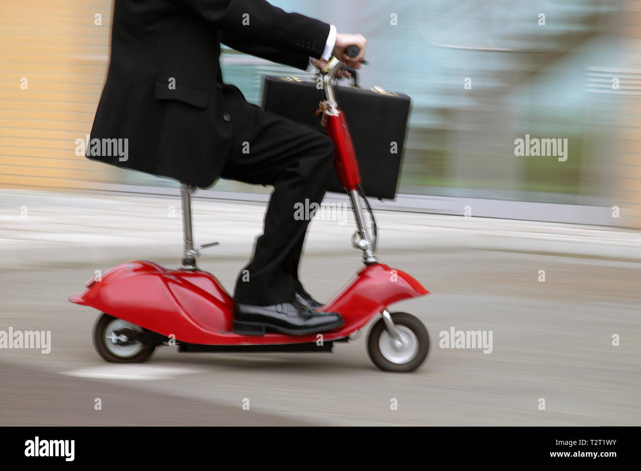 Low angle view of a commuter on Motorised Scooter Stock Photo - Alamy