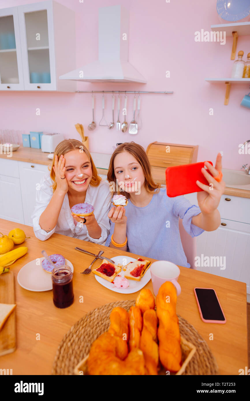 Funny selfie. Lovely sisters enjoying their family day making funny