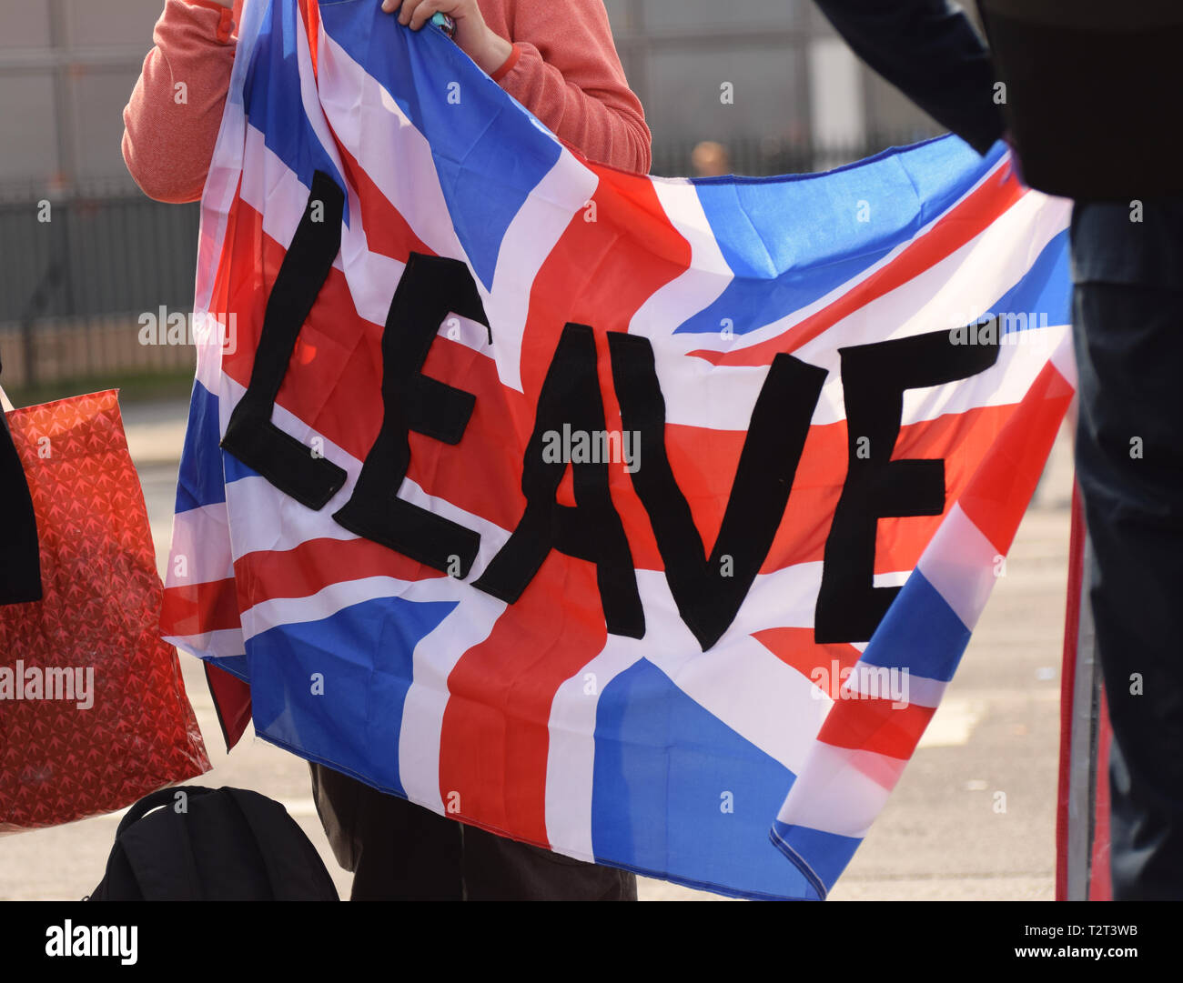 A British Union Flag with the word 'Leave' on it being carried by pro Brexit demonstrators in Parliament Square London UK Stock Photo