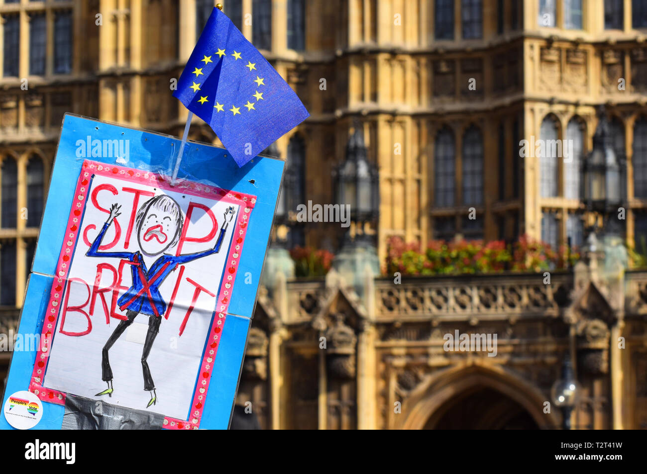 A Stop Brexit Protest Sign showing a cartoon drawing of Theresa May being waved in front of the House of Commons, Westminster, London UK Stock Photo