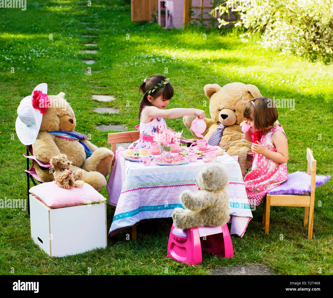 Elevated view of two young caucasian girls playing Teddy Bears Picnic Stock Photo