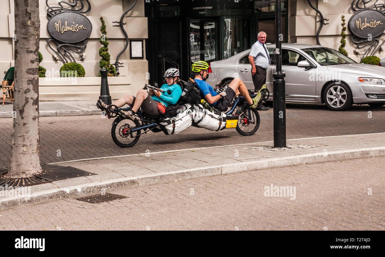 A recumbent back to back tandem cycle in Newcastle with male and female riders on board Stock Photo