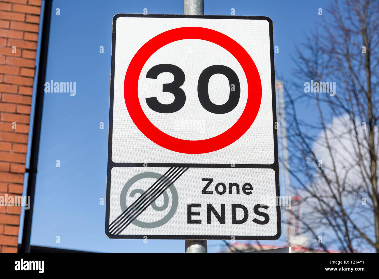 A UK Road Traffic 30 mph speed limit sign signifying the end of a 20 mph zone Stock Photo