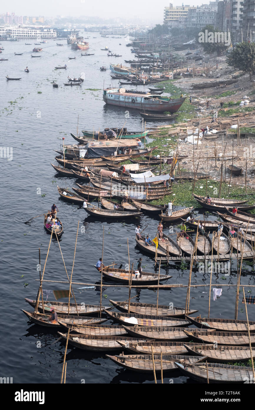 Boats crossing Buriganga river, Dhaka. They carry people and cargo. Babubazar bridge view. Rivers are important part of Bangladesh transport system. Stock Photo