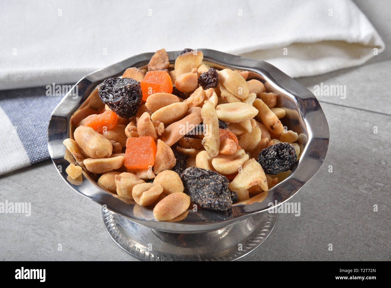 Snack mix with peanuts, cashews, raisins and tropical fruit Stock Photo