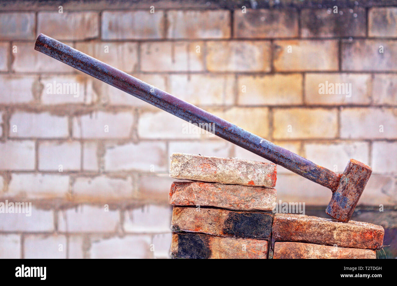 Big demotition hammer with brick background Stock Photo