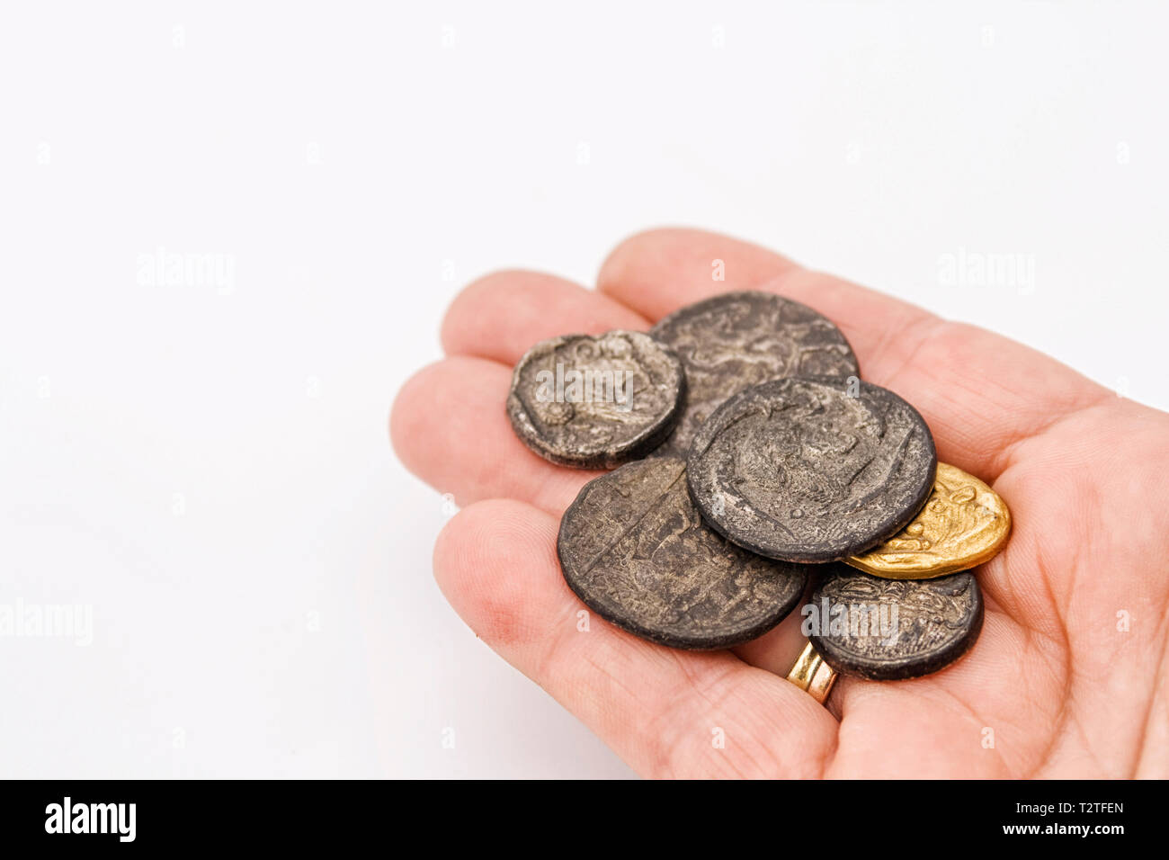 hand with a collection of old roman coins Stock Photo