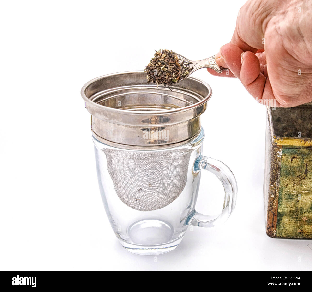 Putting tea leaves in tea strainer Stock Photo Alamy