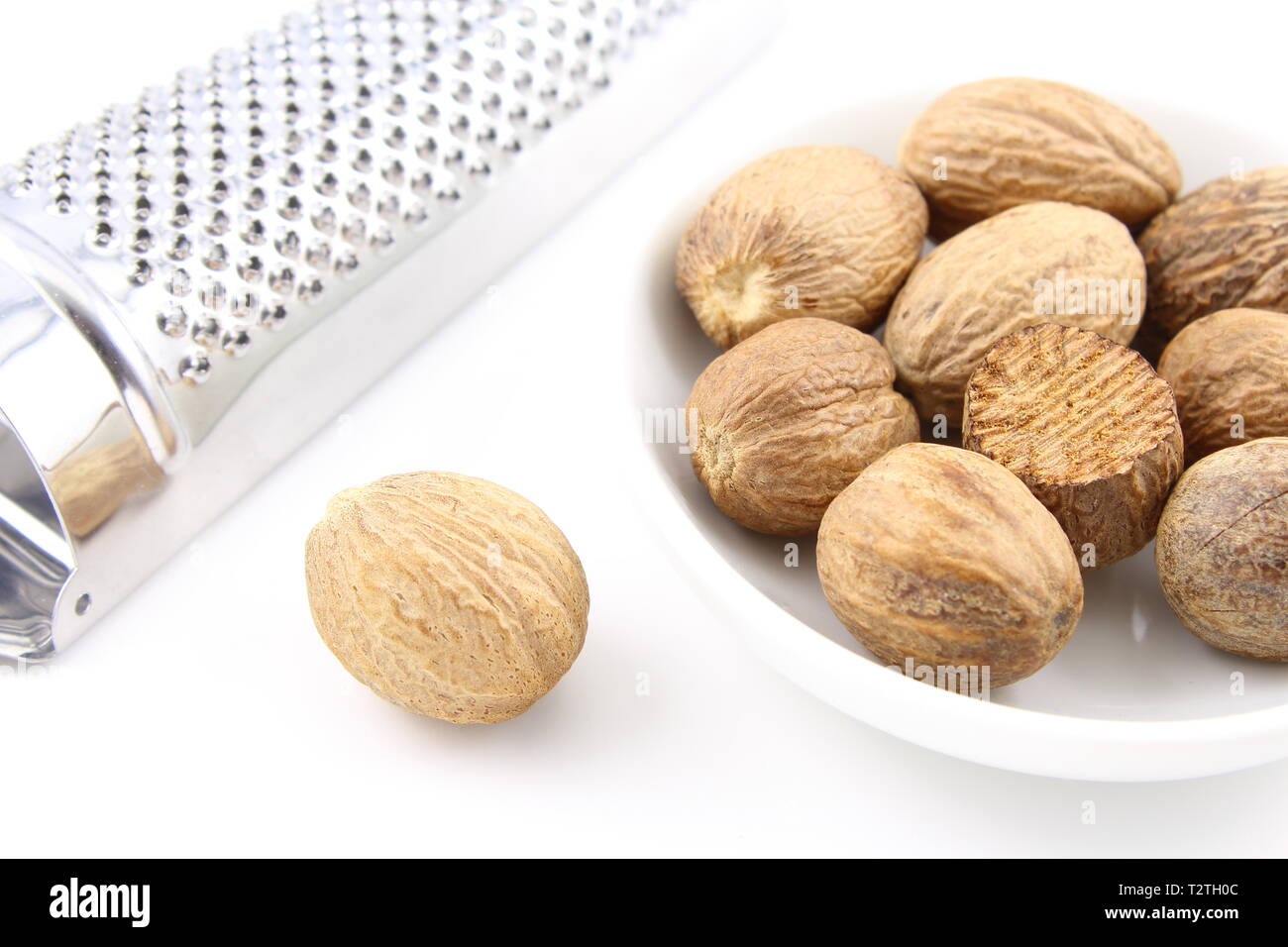 composition of nutmeg seeds in a small white bowl Stock Photo Alamy