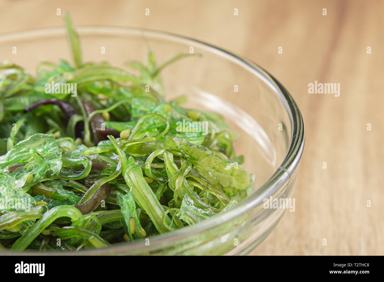 wakame salad with sesame in a small glass bowl closeup with copy space Stock Photo