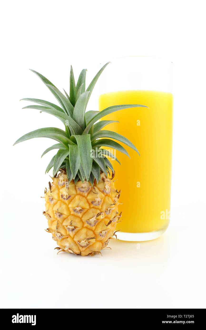 composition of a fresh pineapple and a glass of pineapple juice