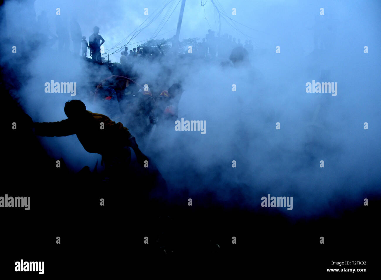 Dhaka, Bangladesh. 4th Apr, 2019. Smoke billows after a fire broke out at a kitchen market in Dhaka, Bangladesh, April 4, 2019. An early morning fire gutted dozens of shops in a kitchen market in Bangladesh capital Dhaka on Thursday, Kazi Nazmuzzaman, deputy assistant director of Fire Service and Civil Defense, told Xinhua. Credit: Stringer/Xinhua/Alamy Live News Stock Photo