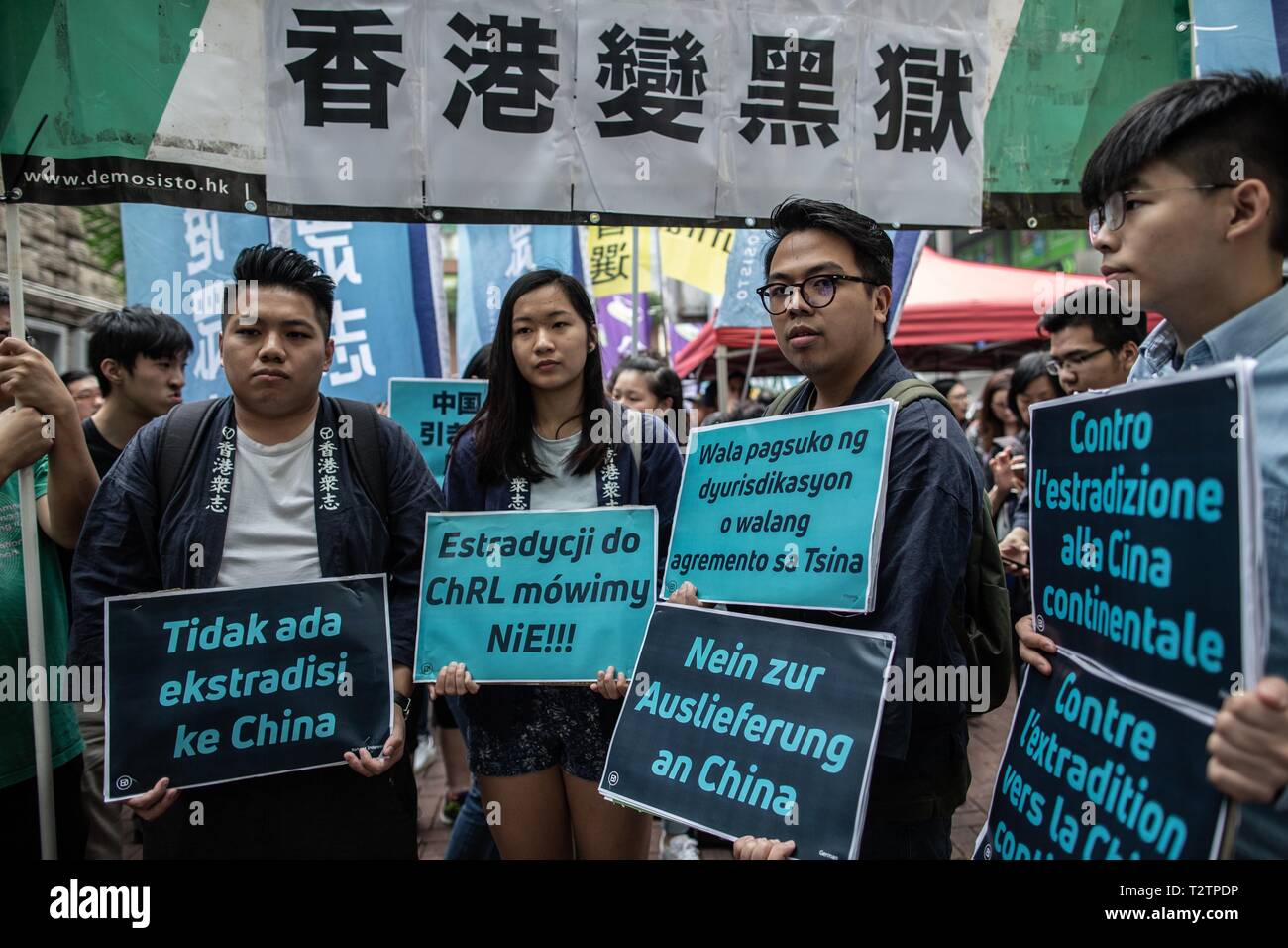 Hong Kong, Hong Kong. 31st Mar, 2019. Ivan Lam (R-2), chairman of  pro-democratic party Demonstrator, alongside Joshua Wong, seen holding  placards in different languages protesting against the new law  proposals.Extradition laws were