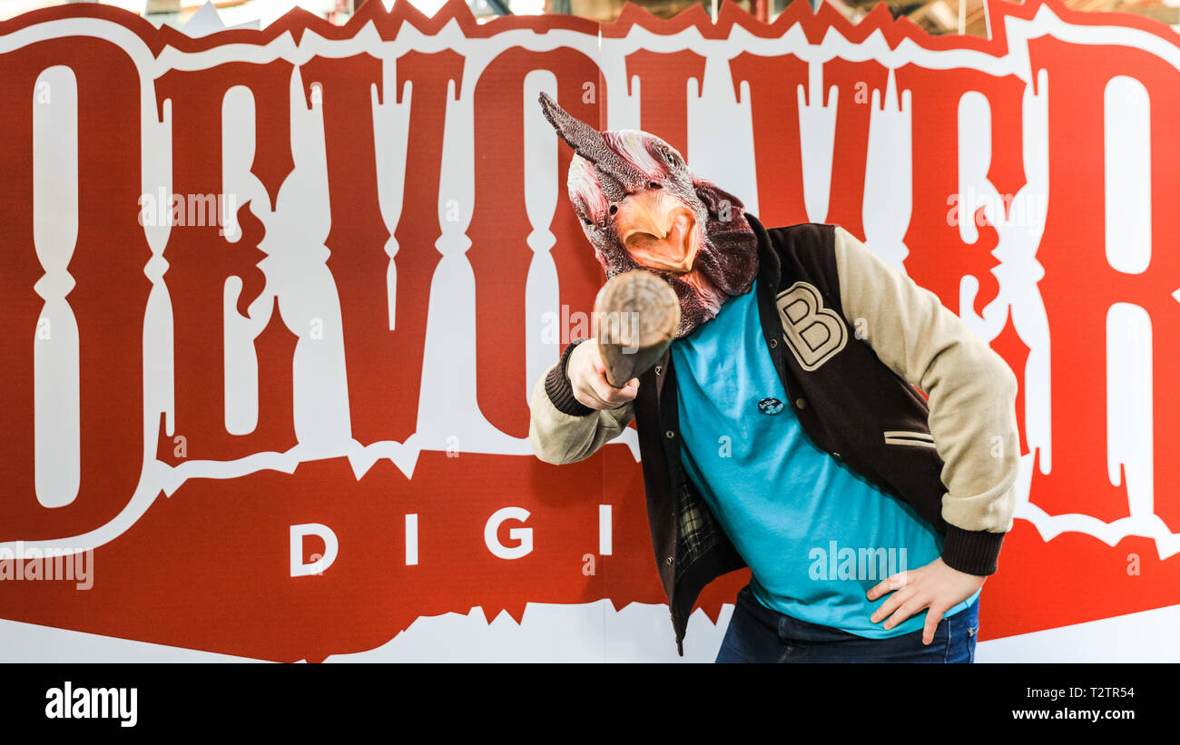 Tobacco Dock, London, UK, 4th April 2019.  A cockerel character from Hotline Miami, a Devolver Digital game. Gamers, developers and console players of all ages once again meet at EGX Rezzed in London's Tobacco Dock, which showcases the latest games, including pre-releases, as well as encouraging visitors to try and play both interactive video games as well as some old-fashioned board games. Rezzed runs April 4-6th and is part of London Games Festival. Credit: Imageplotter/Alamy Live News Stock Photo